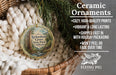 Ceramic ornaments, featuring a vintage-style image of a forest scene, are displayed in a wicker basket.