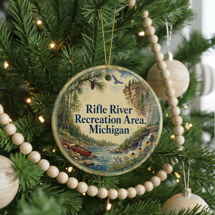 A round ornament on a Christmas tree, featuring a scenic image of the Rifle River Recreation Area in Michigan.