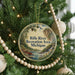 A round ornament on a Christmas tree, featuring a scenic image of the Rifle River Recreation Area in Michigan.