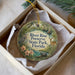 A decorative ornament in a box, featuring illustrations of wildlife and nature elements, with the text "River Rise Preserve State Park, Florida" prominently displayed.