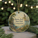 A round ornament with a lighthouse and a scenic landscape, featuring the text "Rocky Neck State Park, Connecticut" on it, is displayed in front of a blurred background with Christmas lights.