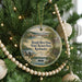 A round ornament hanging on a Christmas tree, featuring a scenic view of the Rough River Dam and State Resort Park in Kentucky.