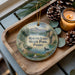 A wooden tray displaying a decorative ornament with a scenic landscape of Round Lake State Park, Idaho, featuring a lake, mountains, pine trees, and a duck.
