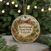 A round ornament with a scenic image of the Rocky Mountains and a bird, hanging on a string.