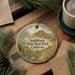 A decorative ornament featuring a scenic landscape of Saddleback Butte State Park, California, with a mountain and a stream in the background.