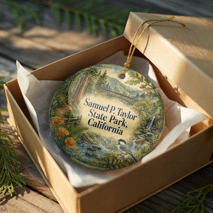 A decorative ornament in a box, featuring a scenic landscape with trees, flowers, and a bird, along with the text "Samuel P. Taylor State Park, California".