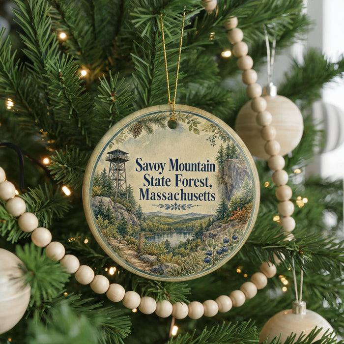 A round ornament hanging on a Christmas tree, featuring a scenic landscape with a tower in the background.