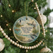 A round ornament hanging on a Christmas tree, featuring a lighthouse and a bird, with the text " Sebastian Inlet State Park, Florida" printed on it.