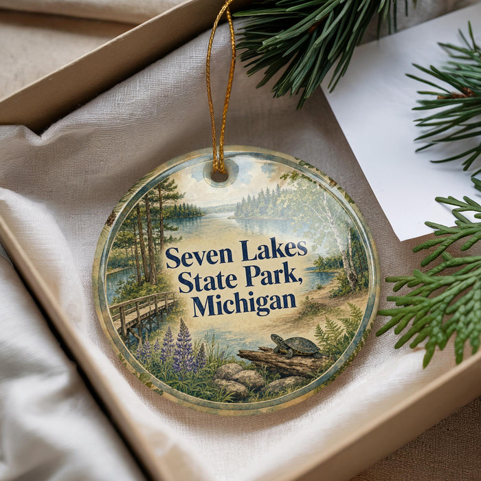 A decorative ornament with a scenic image of Seven Lakes State Park, Michigan, hanging from a string.