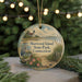 A round ornament with a lighthouse and a bird, surrounded by greenery and a string of lights, representing Sherwood Island State Park, Connecticut.