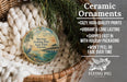 Ceramic ornaments, featuring a bird and a pier, are displayed in a basket with greenery.