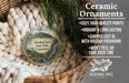 Ceramic ornaments, specifically Sleeping Giant State Park, Connecticut ornaments, are displayed in a basket with pine branches.
