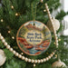 A round ornament hanging on a Christmas tree, featuring a scenic image of Slide Rock State Park in Arizona.