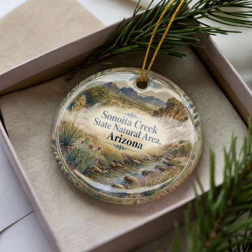 A decorative ornament in a box, featuring a scenic landscape of Sonoita Creek, the Sonoita Creek State Natural Area in Arizona.