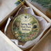A decorative ornament in a white box, featuring a scenic image of Spring Mill State Park, Indiana.
