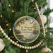 A circular ornament hanging on a Christmas tree, featuring a scenic image of St. Bernard State Park in Louisiana.