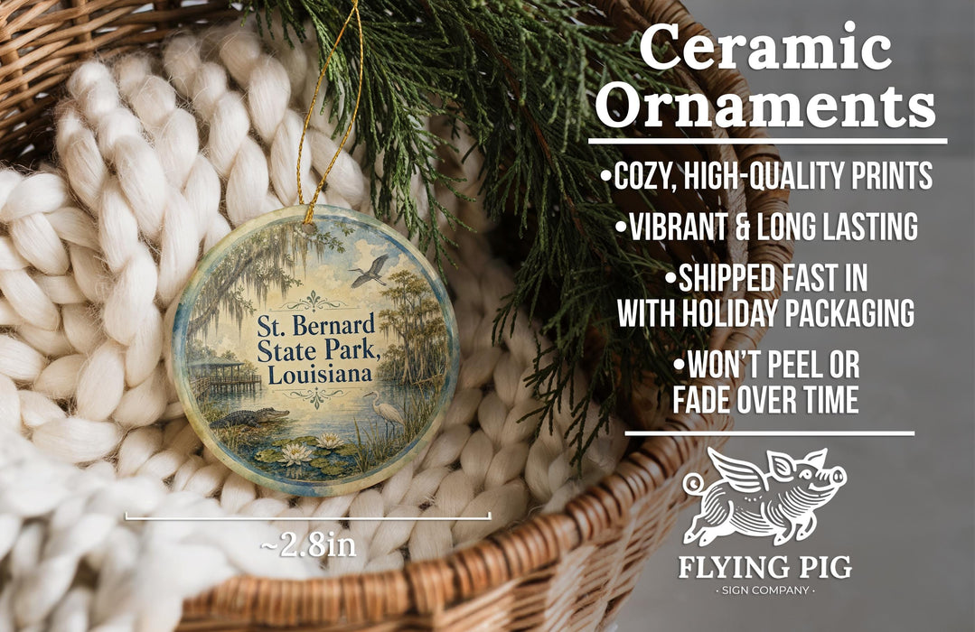 Ceramic ornaments, specifically St. Bernard State Park or Louisiana ornaments, are displayed in a basket with greenery.