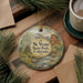 A round ornament with a scenic landscape of St. Vrain State Park, Colorado, featuring a river, mountains, and pine trees.