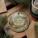 A round ornament with a scenic image of State Forest State Park, Colorado, hanging on a wooden surface.