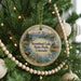 A round ornament hanging on a Christmas tree, featuring a scenic image of Steamboat Lake State Park, Colorado.