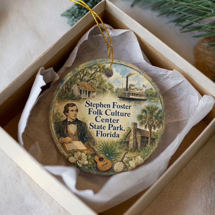 A decorative ornament in a box, featuring a painting of a man playing a guitar and surrounded by various landmarks and scenes, including a ship and palm trees.