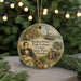 A round ornament featuring a portrait of a man, surrounded by illustrations of a house, a boat, and palm trees, with the text "Stephan Foster Folk Culture Center State Park, Florida" displayed on it.