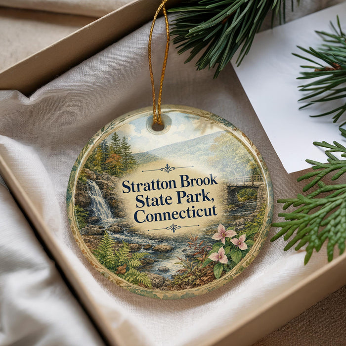 A decorative ornament with a scenic image of Stratton Brook State Park, Connecticut, hanging from a string.