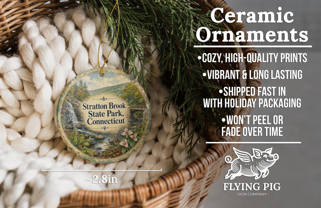 Ceramic ornaments, featuring a scenic image of Stratton Brook State Park, Connecticut, are displayed in a woven basket.