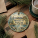 A round ornament with a scenic landscape of Swietzer Lake, State Park, Colorado, hangs on a wooden surface.