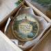 A round ornament with a scenic image of Syvan Lake State Park, Colorado, hanging from a string.