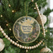 A circular ornament hanging on a Christmas tree, featuring a scenic image of Tallulah Gorge State Park in Georgia.