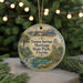 A round ornament with a painting of a scenic view of Tarpon Springs Heritage State Park, Florida, hanging on a string.