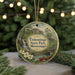 A circular ornament with a scenic landscape of Tishomingo State Park, Mississippi, featuring a waterfall, bridge, and boat.