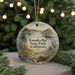 A round ornament with a scenic image of Tomales Bay State Park, California, featuring a lake, trees, and birds.