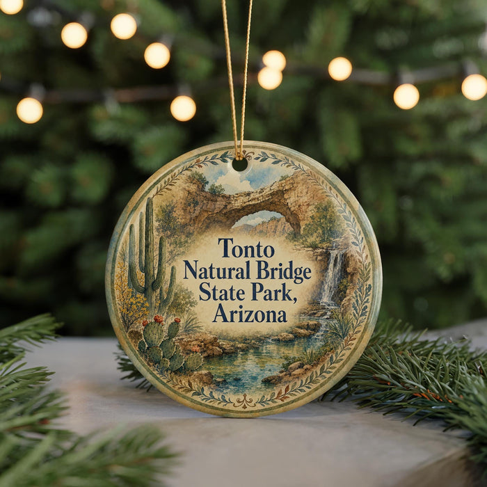 A round ornament with a scenic image of Tonto Natural Bridge State Park, Arizona, hanging from a string.