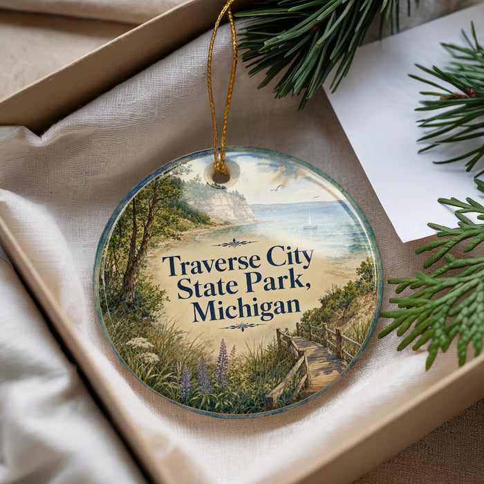 A round ornament with a scenic image of Traverse City State Park, Michigan, hanging from a string.