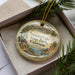 A decorative ornament with a scenic landscape of mountains, trees, and a lake, featuring the text "Trinidad Lake State Park, Colorado".