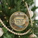 A round ornament hanging on a Christmas tree, featuring a scenic image of Trinidad Lake State Park, Colorado.