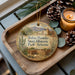 A wooden tray with a decorative ornament featuring a desert landscape and the text "Tubac Presidio State Historic Park, Arizona".
