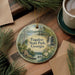 A round ornament with a scenic landscape of Tugalo State Park, Georgia, featuring a waterfall, pine trees, and a cabin.