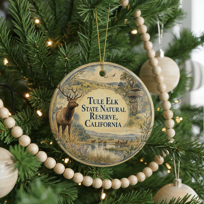 A round ornament hanging on a Christmas tree, featuring a deer and the text "Tule Elk State Natural Reserve, California".