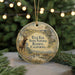 A round ornament with a deer and a scenic landscape, hanging from a string.