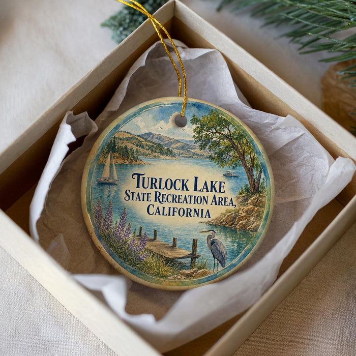 A decorative ornament in a white box, featuring a scenic image of Turlock Lake, California.