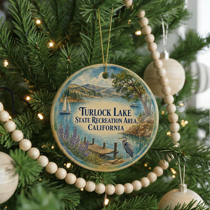 A circular ornament hanging on a Christmas tree, featuring a scenic image of Turlock Lake, California.