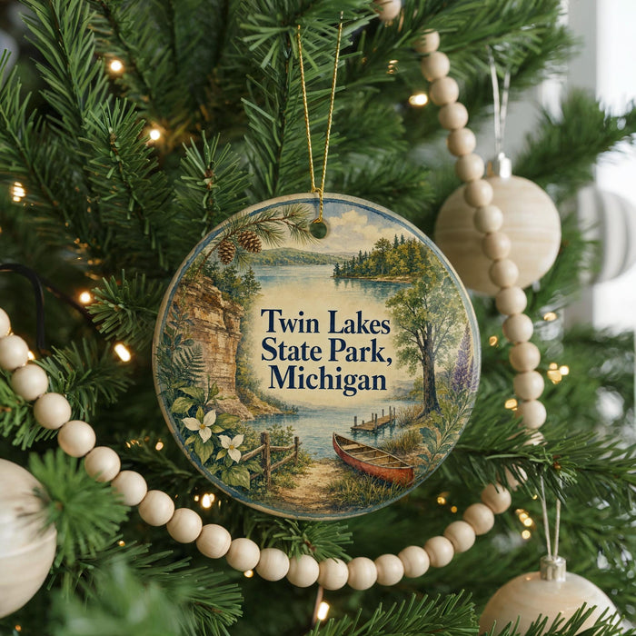 A round ornament on a Christmas tree, featuring a scenic image of Twin Lakes State Park in Michigan.