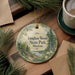 A decorative ornament with the text "Vaughan Woods State Park, Maine" is displayed on a wooden surface, surrounded by pine branches and a cup of coffee.