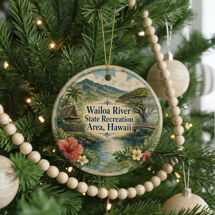 A circular ornament hanging on a Christmas tree, featuring a tropical landscape with palm trees, a house, and a river.