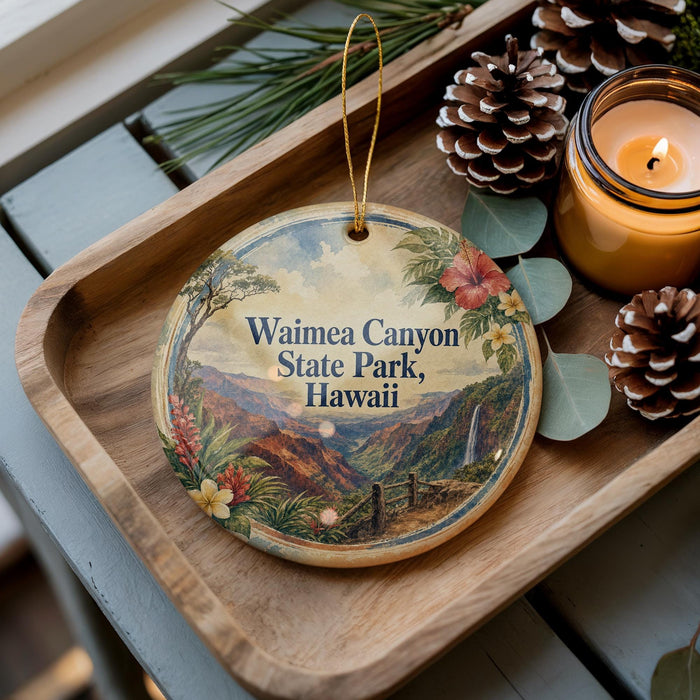 A decorative ornament with a scenic image of Waimea Canyon State Park, Hawaii, is displayed on a wooden tray alongside pine cones and a lit candle.