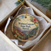 A decorative ornament in a box, featuring a scenic image of Waimea Canyon State Park in Hawaii.