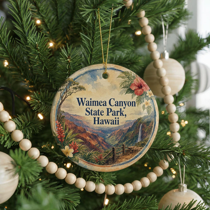 A round ornament on a Christmas tree, featuring a scenic image of Waimea Canyon State Park in Hawaii.